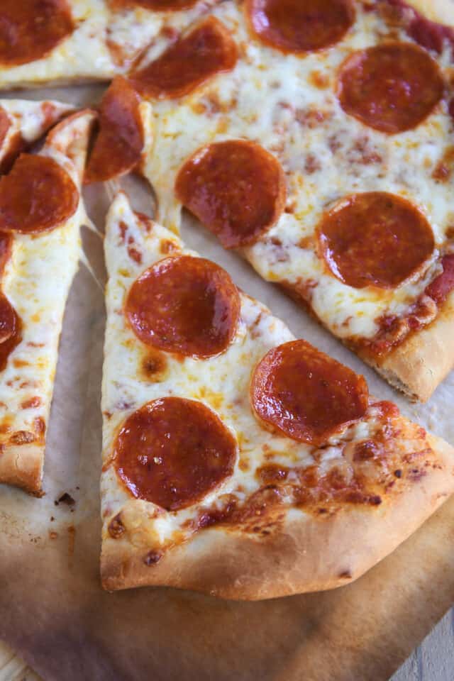 Triangular slice of pepperoni pizza.