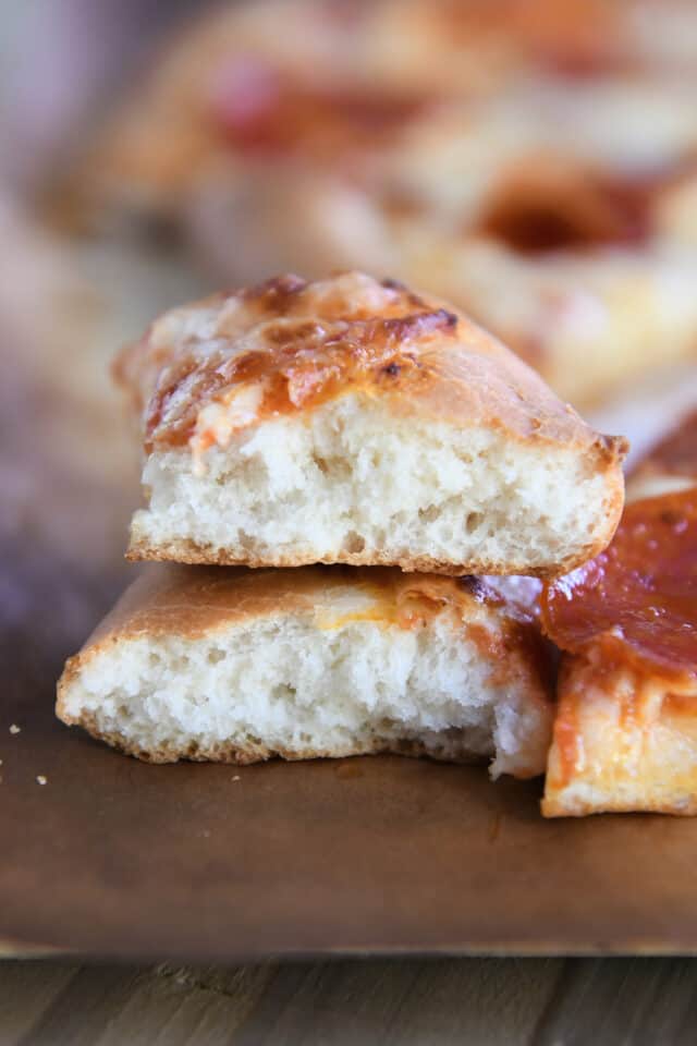 Two pieces of fluffy pizza crust on top of each other.