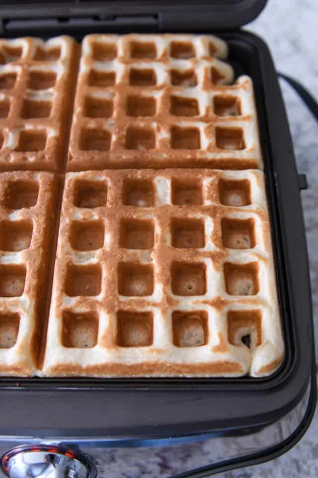 Cooked waffle on waffle iron.