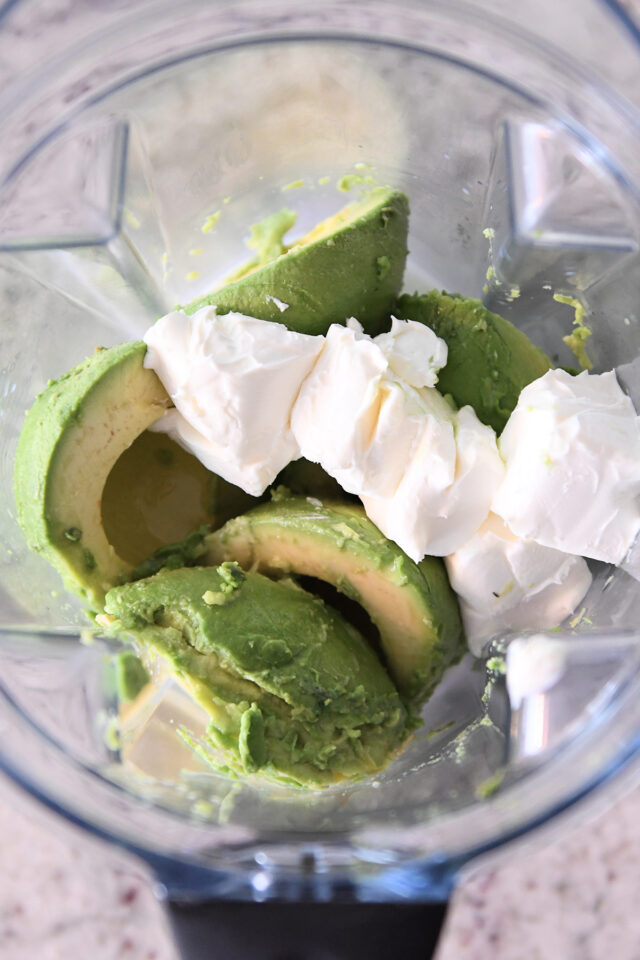 Place avocado and cream cheese in blender.