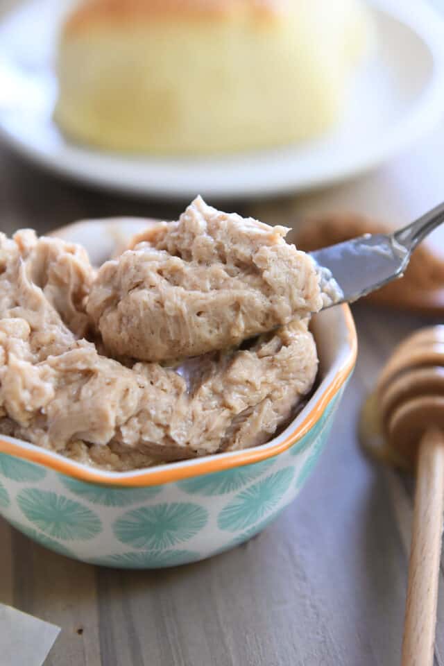 Place a ball of cinnamon honey butter on a knife.