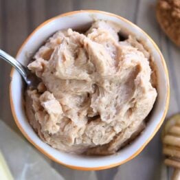 Cinnamon honey butter in bowl with knife.