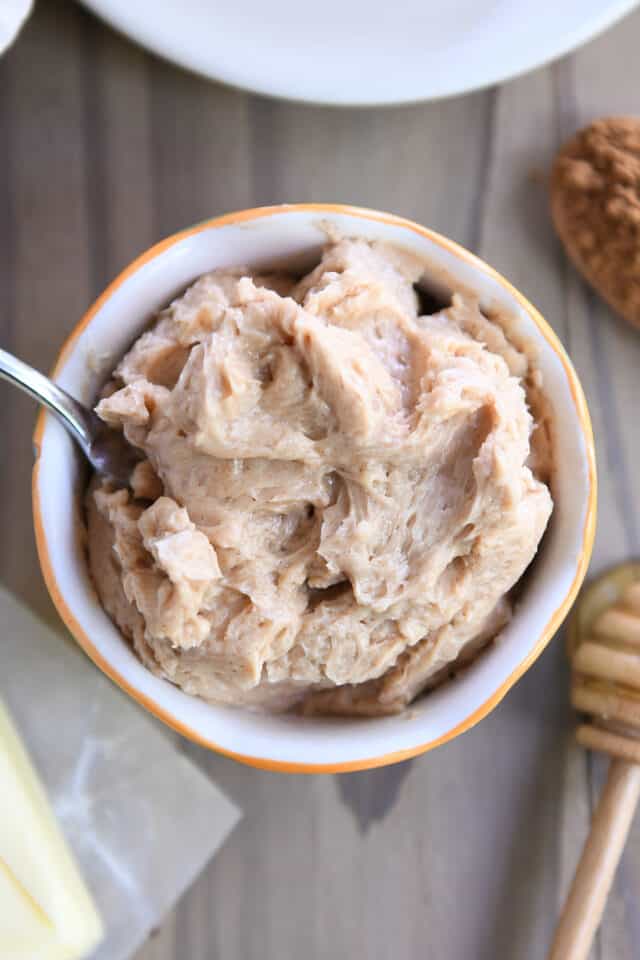 Cinnamon honey butter in a small bowl with a knife.