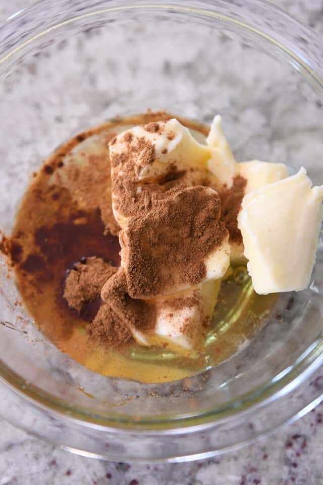 Butter, cinnamon and honey in glass bowl.