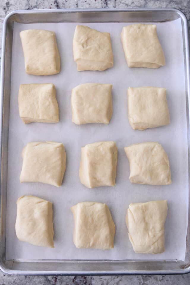 12 unbaked square rolls on baking sheet.