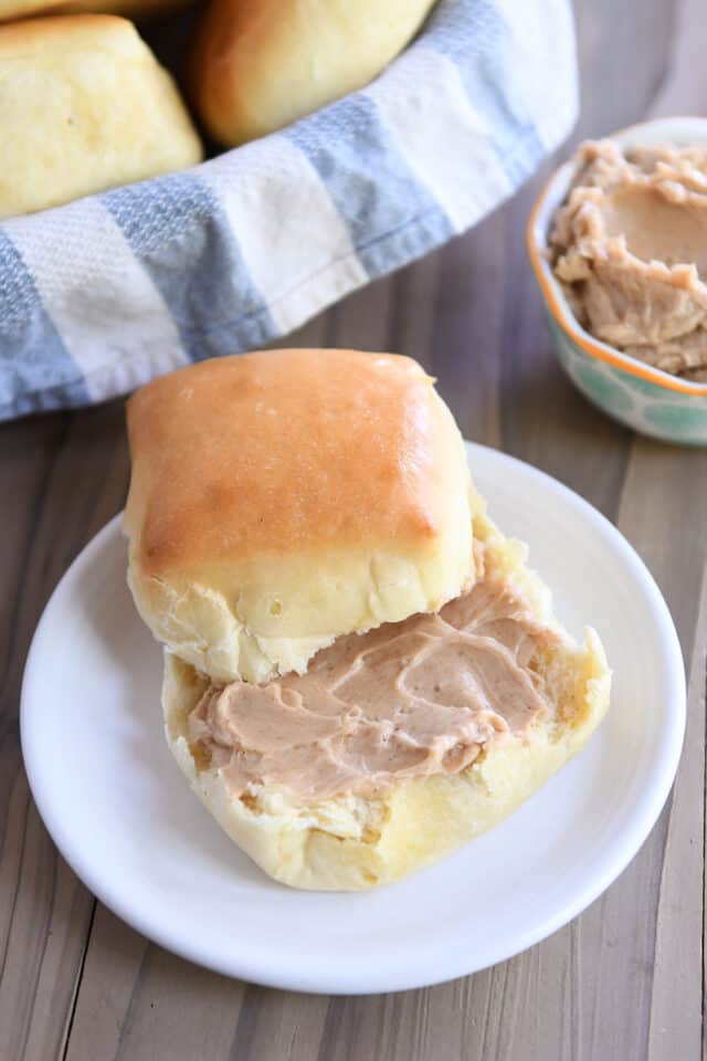 Roll split in half with cinnamon butter on bottom half.