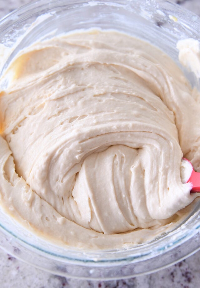 Vanilla cake batter swirled in glass bowl.