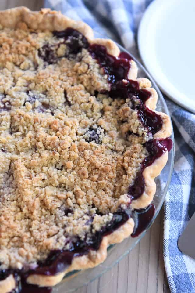 Triple berry rhubarb pie in glass pie plate