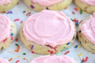 Pressed sugar cookie with sprinkles and pink frosting.