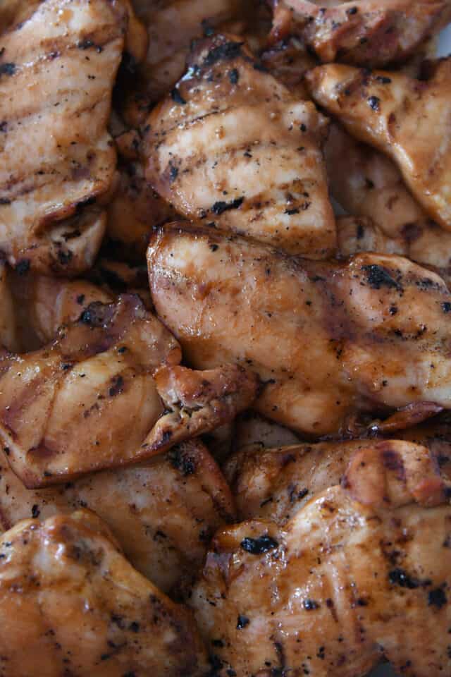 Grilled teriyaki chicken in white dish.