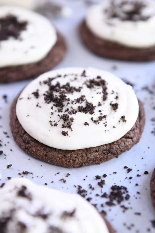 Chocolate Oreo cookie with frosting and Oreo crumbs.