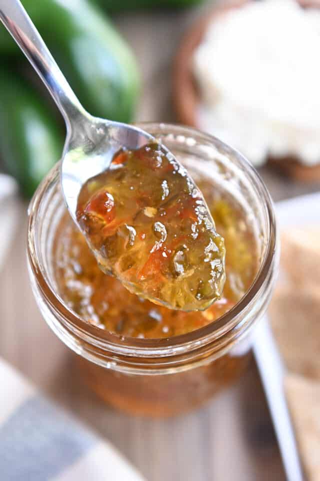 Spoon with jalapeno hot pepper jelly.