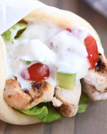 Chicken gyro wrapped in parchment paper.