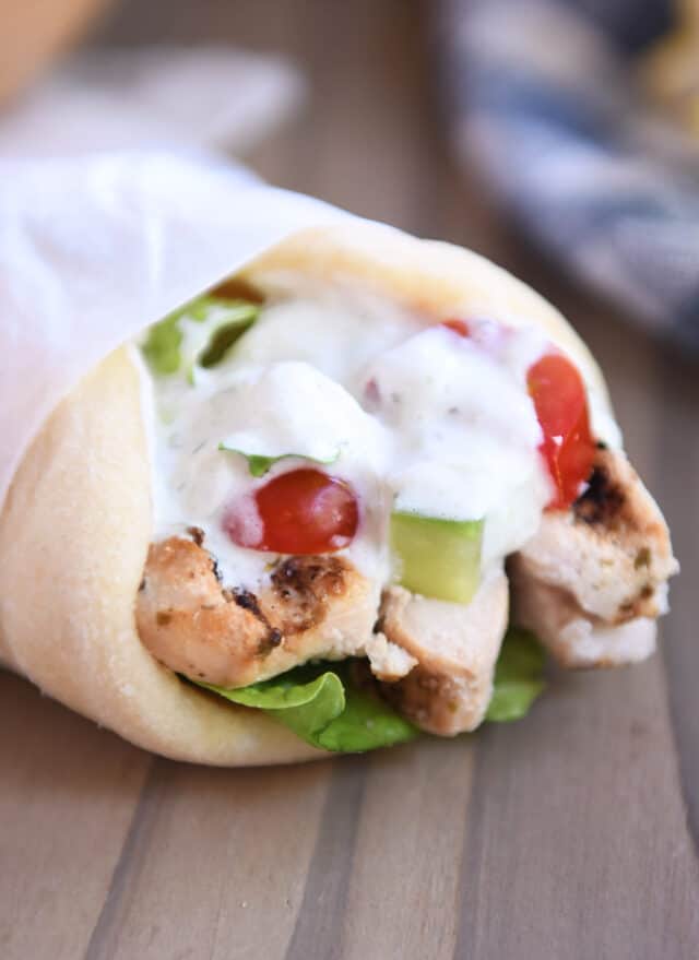 Chicken gyro in flatbread wrapped in parchment.