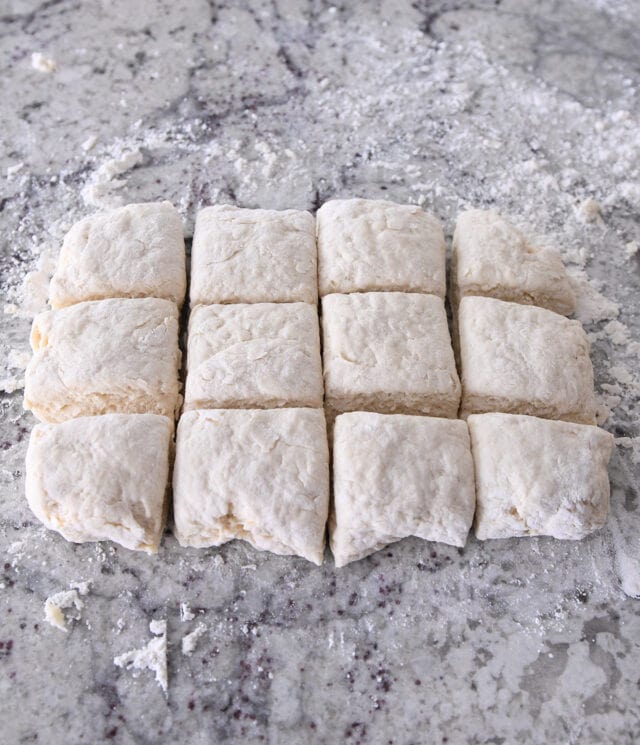 Cutting biscuit dough into 12 pieces.