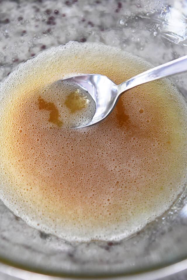 Glass bowl with spoon and brown butter.