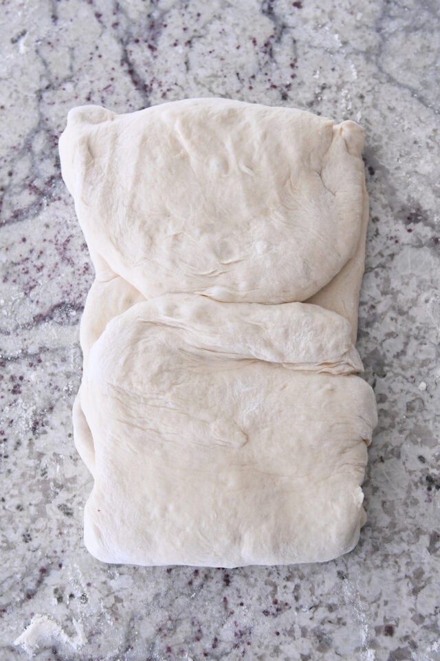 Dough folded into thirds for twisted croissant bread.