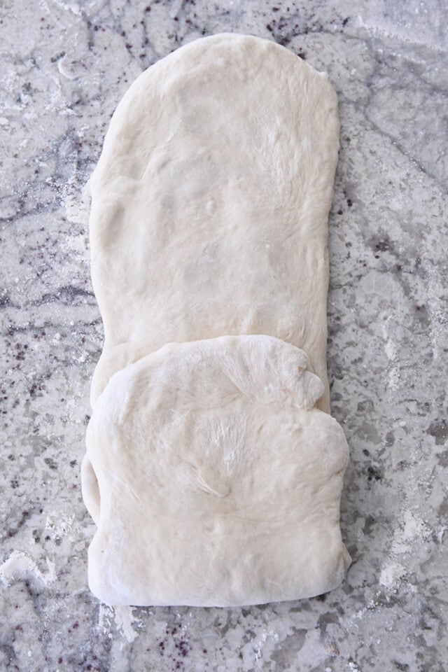 One short end of dough folded to middle of long rectangle.