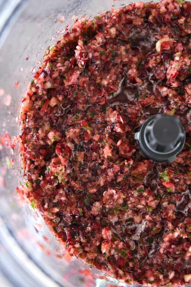 Food processor with chopped fresh cranberries, finely chopped jalapenos and sugar.