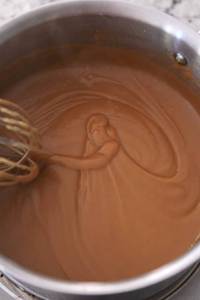 Whisk swirling gravy in saucepan.