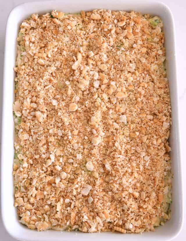 Buttery ritz cracker topping over the top of casserole in white 9X13-inch pan.