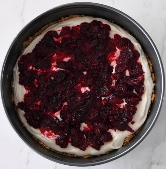 Cranberry jam over cheesecake batter in springform pan.