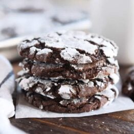 Four chocolate crinkle cookies stacked.