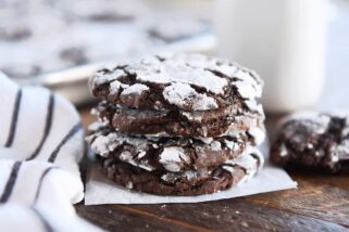 Four chocolate crinkle cookies stacked.