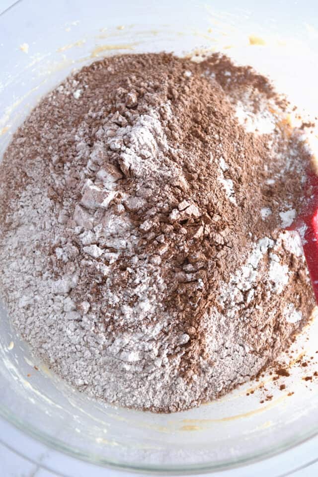 Glass bowl with flour and cocoa powder sifted.
