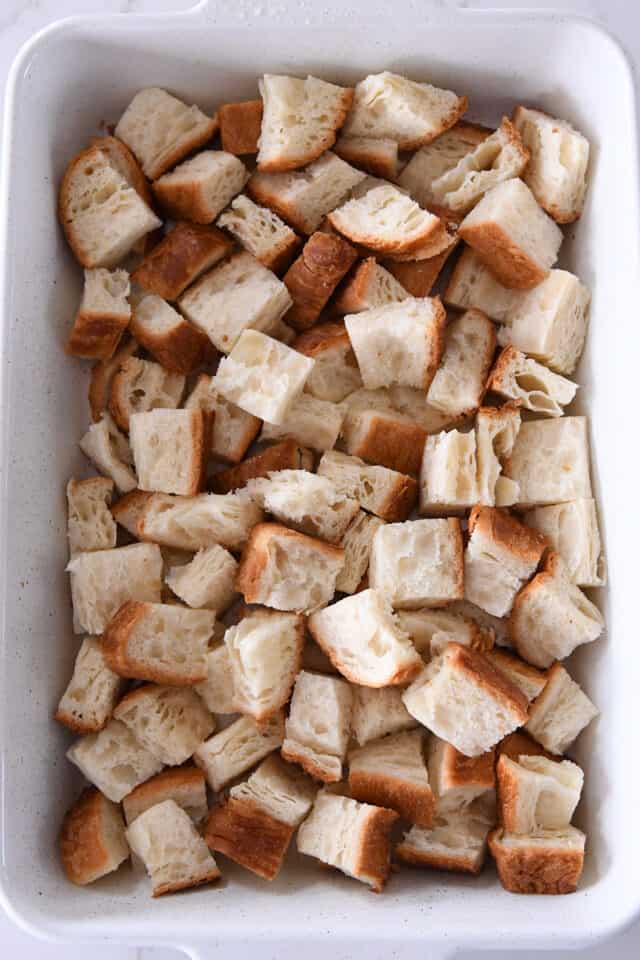 White pan with bread cubes.