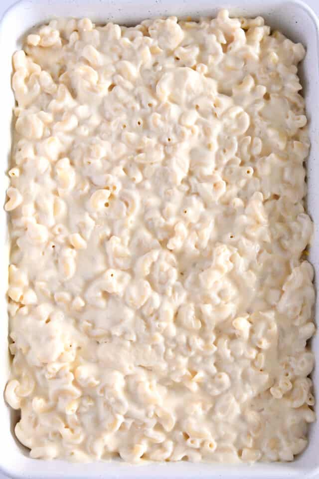 Top down view of assembled macaroni and cheese in white dish.