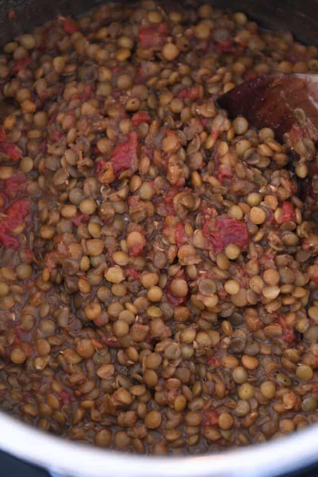 Cooked lentils with red salsa in Instant Pot.