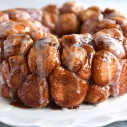 Monkey bread turned out onto white tray and glazed.