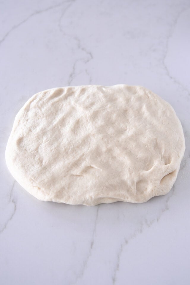 Soft dough patted into thick rectangle.