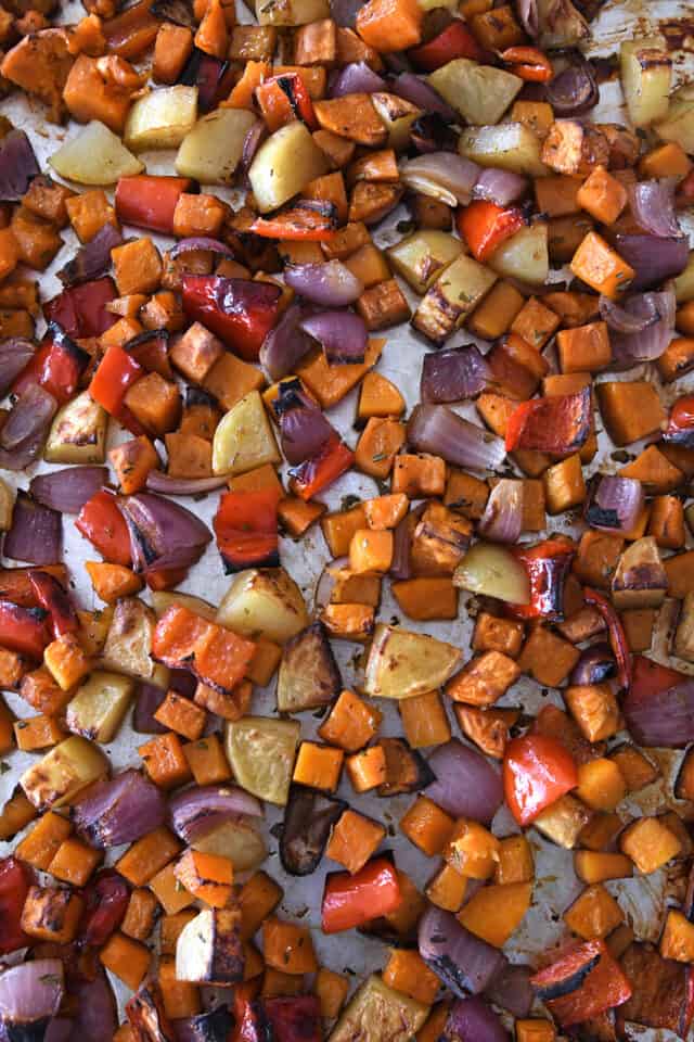 Cooked and roasted winter veggies on sheet pan.