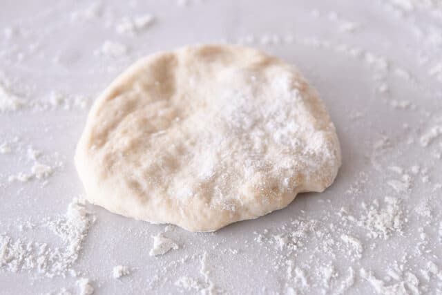 Circle of dough on floured counter.