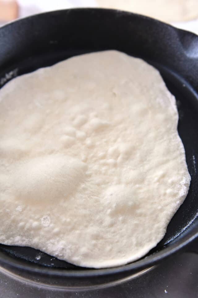 Flatbread cooking in cast iron skillet.