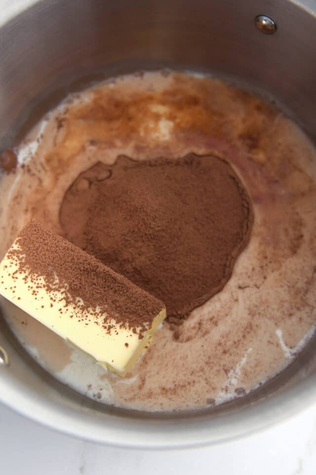 Butter, cocoa powder and milk in saucepan.