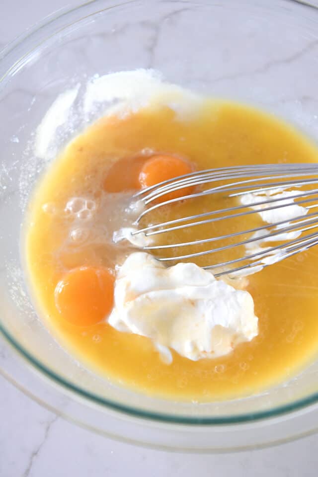 Glass bowl with butter, sour cream, and eggs.