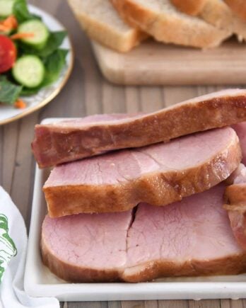 Ham slices on white platter.