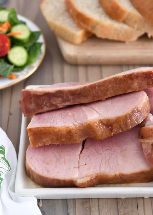 Ham slices on white platter.