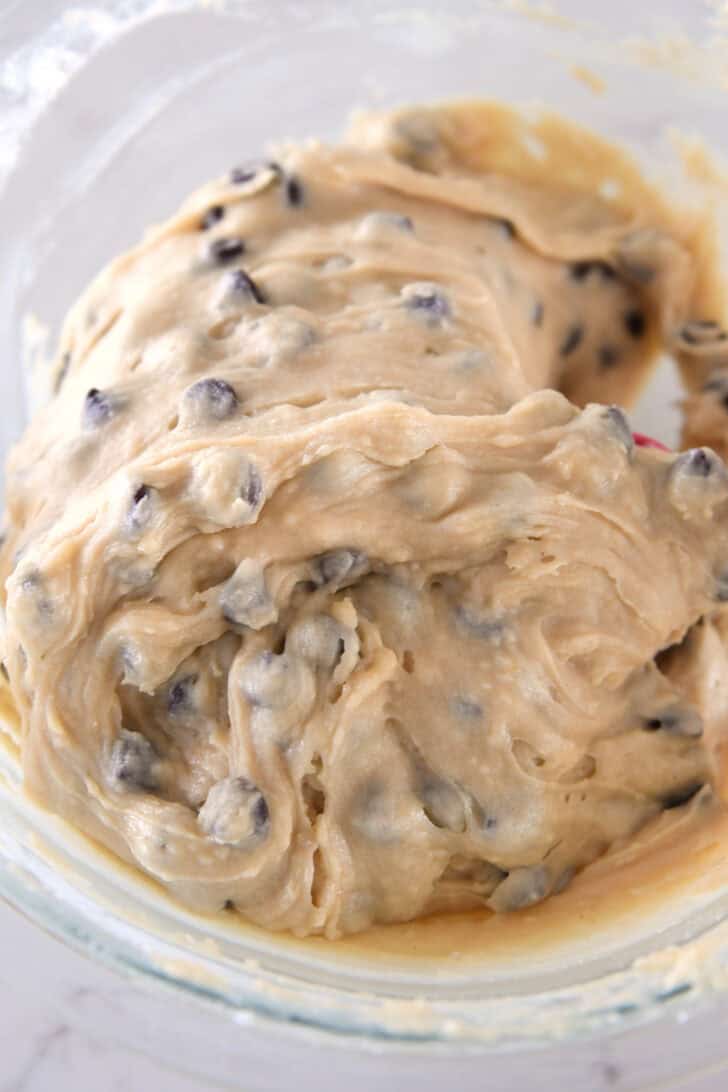 Brown butter chocolate chip muffin batter in glass bowl.