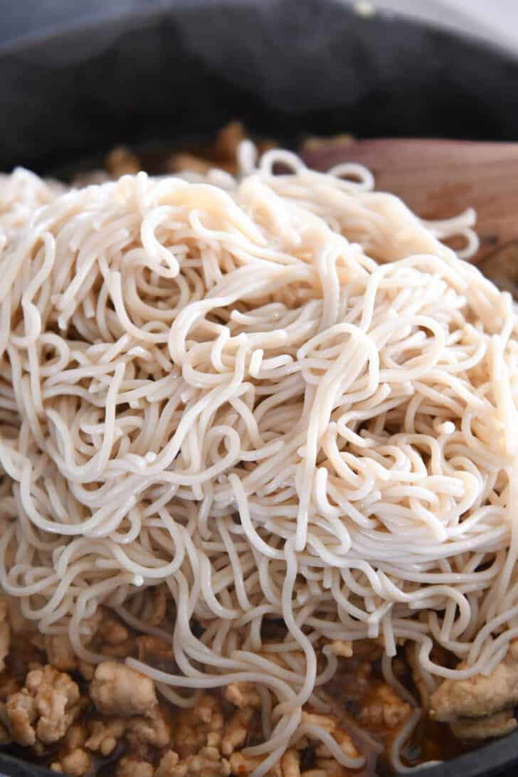 Ramen noodles in skillet with ground turkey.
