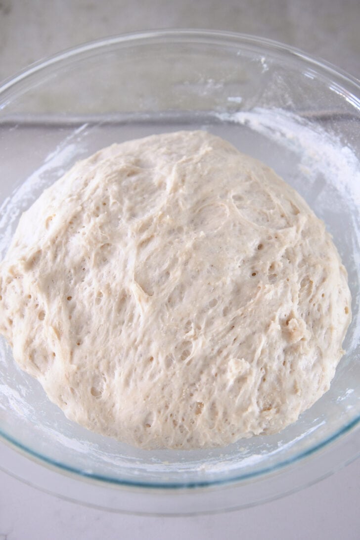 Gl، bowl with risen bread dough.