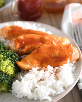 Gray plate with rice and saucy chicken tenders.