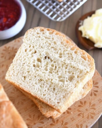Slice of English muffin bread on wood cutting board.