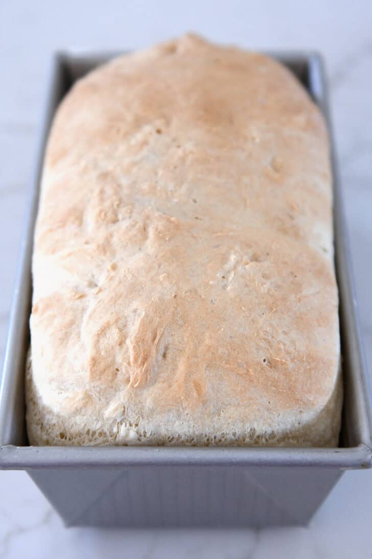 Baked loaf English muffin bread in bread pan.