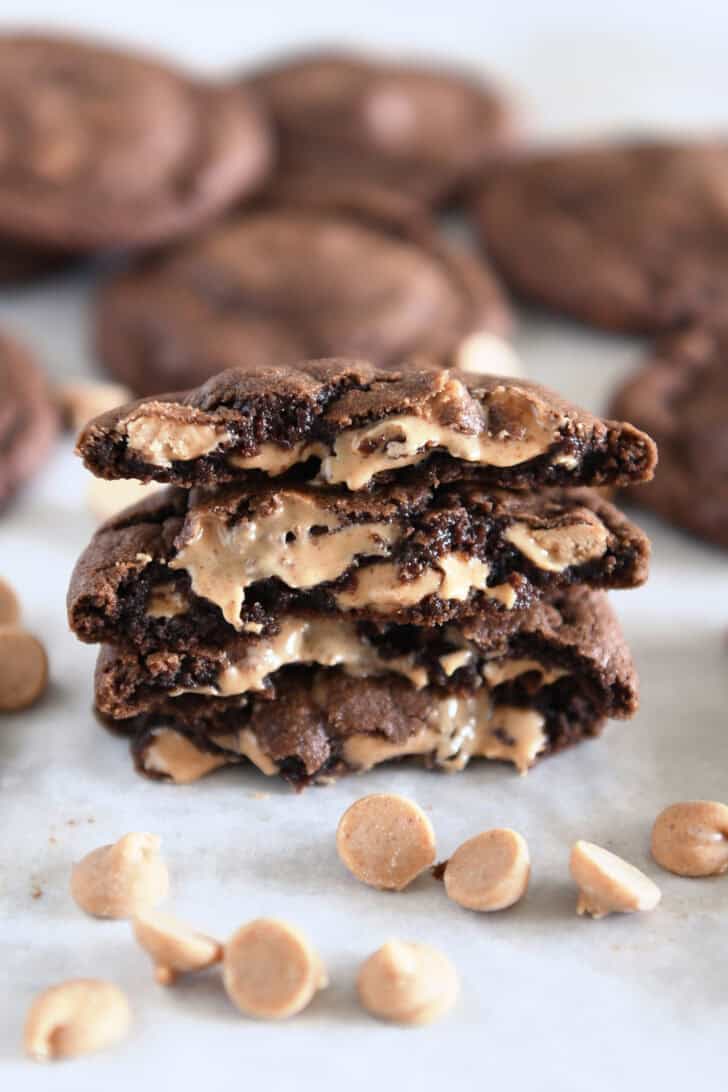 Four half chocolate cookies stacked on each other with melty peanut butter chips.