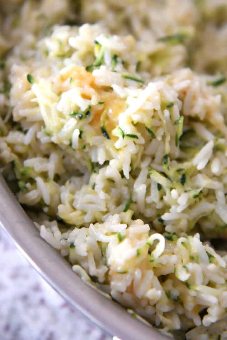 Top view of a pot filled with cheesy zucchini rice.