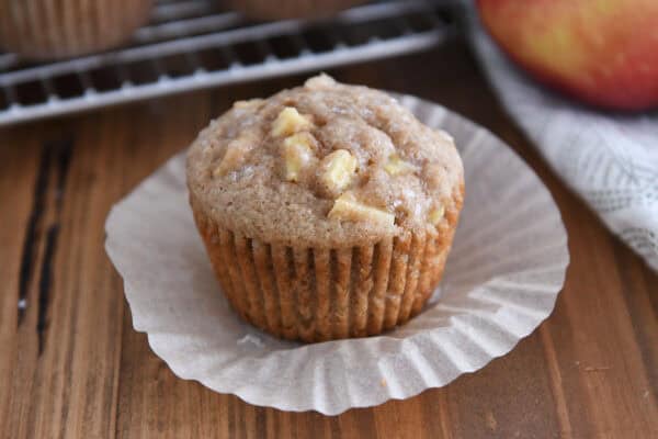 Paper-lined unpacked apple muffins.